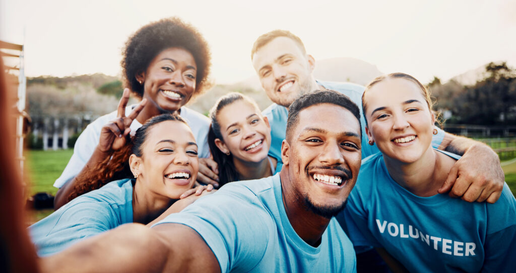 portrait-smile-and-volunteer-group-selfie-festive-season-community-service